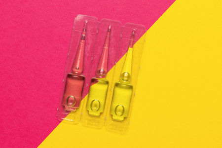 Colorful Interdental Brushes on Vibrant Pink and Yellow Background for Dental Care and Hygiene