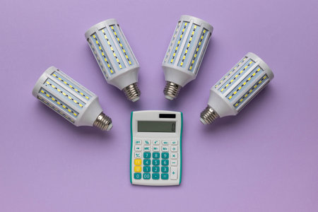 Energy Efficiency Calculation Concept with LED Bulbs and Calculator on Purple Backgroundの写真素材