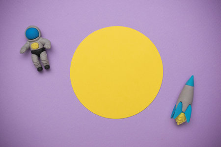 Colorful Space Adventure: Astronaut and Rocket on Purple Background with Yellow Planetの写真素材
