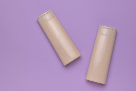 Minimalist Beige Shampoo Bottles on Pastel Purple Background for Beauty and Skincare Concepts