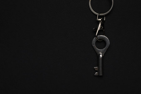 Minimalist Metal Key on Dark Background for Security and Simplicity Themesの写真素材