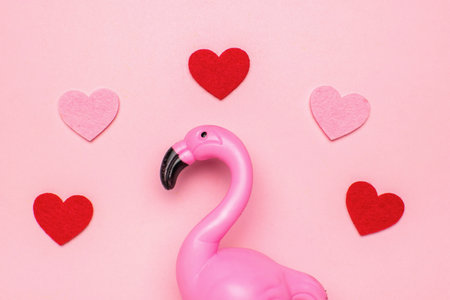 Pink Flamingo and Red Hearts on Soft Pink Background: Symbolizing Love and Serenityの写真素材