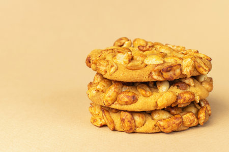 Crunchy Peanut Cookies with Golden Baked Texture on Neutral Backgroundの写真素材
