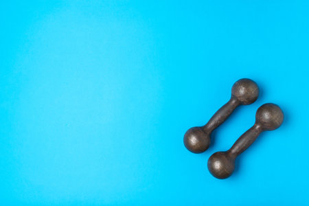 Vintage Dumbbell Fitness on Vibrant Blue Background for Home Workout Inspiration