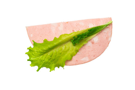 Fresh Lettuce Leaf on Classic Bologna Slice Isolatedの写真素材