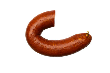 Smoked Sausage on Black Background Traditional Cured Meat Highlighted in Stock Photoの写真素材