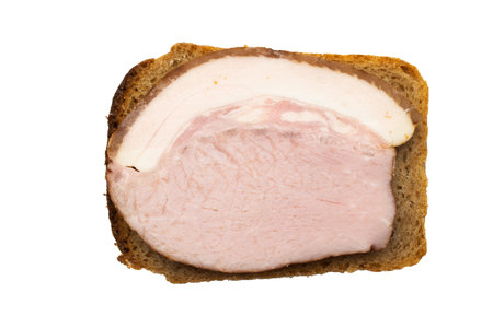 Top View of a Slice of Ham on Bread Against a Black Backgroundの写真素材