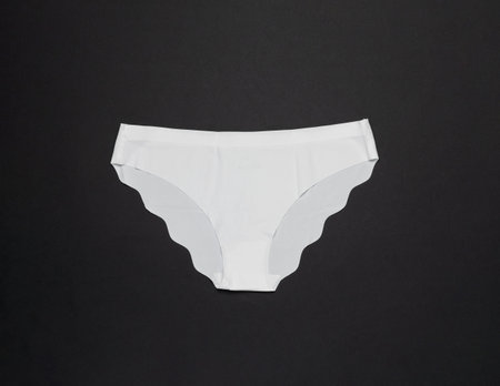 White Seamless Underwear on Black Background - Minimalistic Fashion Photographyの写真素材