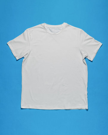 Plain White T-Shirt on Blue Background - Minimalist Fashion Stock Photoの写真素材