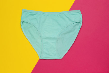Aqua Green Women's Underwear on Colorful Geometric Background for Fashion and Lifestyle Conceptsの写真素材