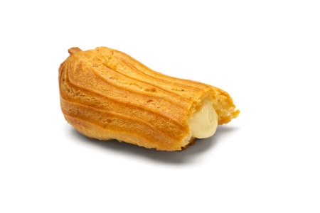 Half Eaten Cream-Filled eclair on White Background Showcasing Delicious Dessert with Sweet Custard...