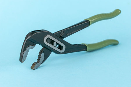 Adjustable Wrench on Blue Background: Essential Hand Tool for Plumbing and Repairs