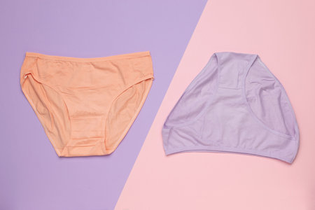 Colorful Pastel Lingerie Display on Split Lavender and Pink Backgroundの写真素材