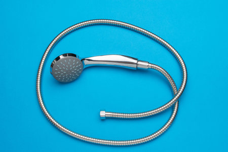 Stainless Steel Shower Head on Blue Background: Modern Bathroom Equipment for Stylish Interiors