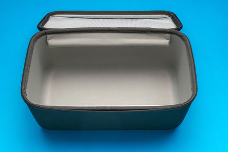 Open Empty Travel Bag with Zipper on Blue Background: Modern and Practical Storage Solution