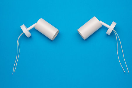 Minimalist White Ceiling Light Fixtures on Vibrant Blue Background