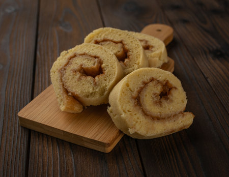 Homemade Cinnamon Rolls on Wooden Board - Cozy Rustic Dessert Perfect for Autumnの写真素材