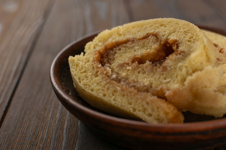 Homemade Cinnamon Roll Cake on Rustic Wooden Table - Cozy, Delicious, Baked Delightの写真素材