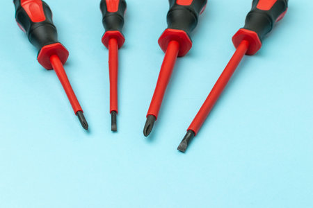 Set of Insulated Screwdrivers on Blue Background: Essential Tools for Electrical Safetyの写真素材