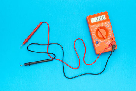 Digital Multimeter with Probes on Vibrant Blue Background - Essential Tool for Electrical...