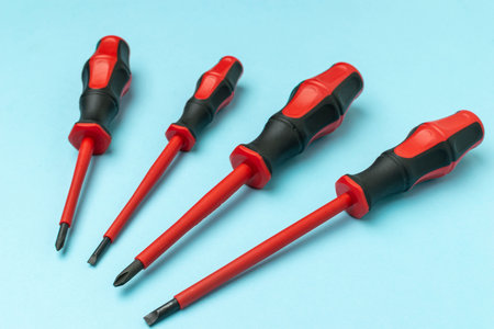Set of Red and Black Screwdrivers on Blue Background - Essentials for Home and Professional Use