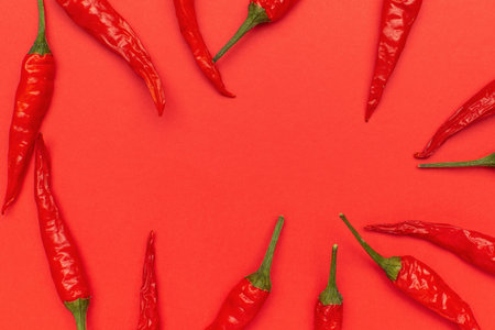 Vibrant Red Chili Peppers on Bold Red Background for Spicy Culinary Inspiration