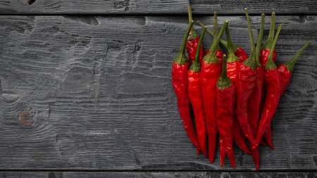Fresh Red Chili Peppers on Rustic Wooden Table - Spicy Culinary Concept and Organic Produce