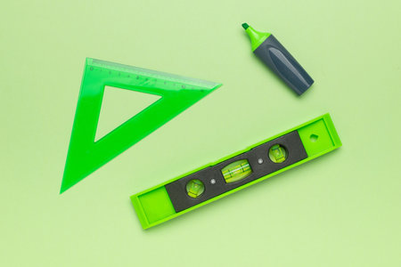 Bright Green Geometric Tools on Lime Background: Ruler, Marker, and Level for Precision and...