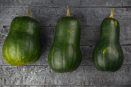 Trio of Green Squash on Rustic Wooden Table - Fresh, Organic, Farm Produce Photographyの写真素材