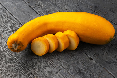 Sliced Yellow Zucchini on Rustic Wooden Surfaceの写真素材