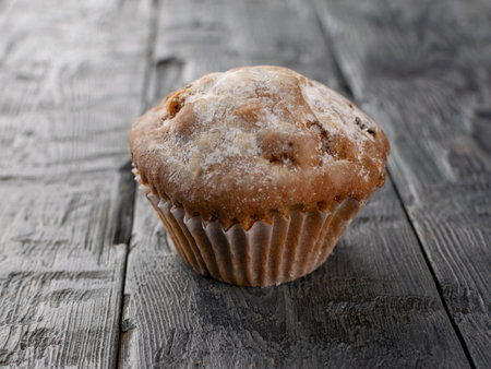 Rustic Muffin on Weathered Wooden Surface Capturing Homestyle Baked Goods Charmの写真素材
