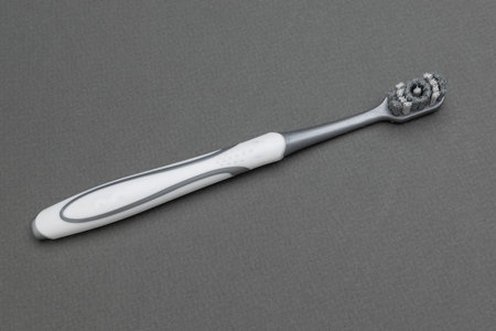 Old Toothbrush on Gray Background Highlighting Wear and Sustainability Conceptの写真素材