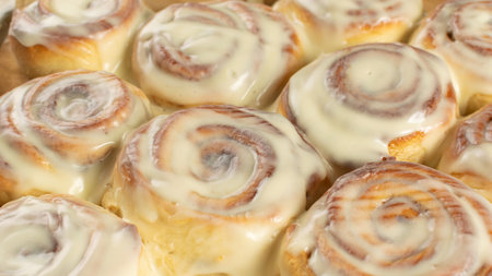 Freshly Baked Cinnamon Rolls with Creamy Icing - Perfect for Breakfast and Dessert Loversの写真素材
