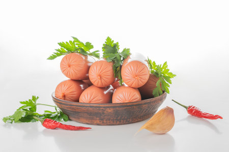 Fresh Sausages with Herbs and Chili Peppers on Wooden Plateの写真素材