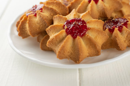Delicious Star-Shaped Cookies with Raspberry Jam on White Plateの写真素材
