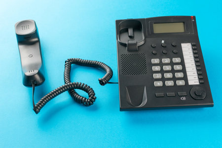 Retro Office Phone with Cordless Handset on Blue Background - Vintage Communication and Business Conceptの写真素材