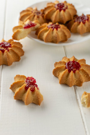 Delicious Raspberry Jam Cookies on White Wooden Table Backgroundの写真素材
