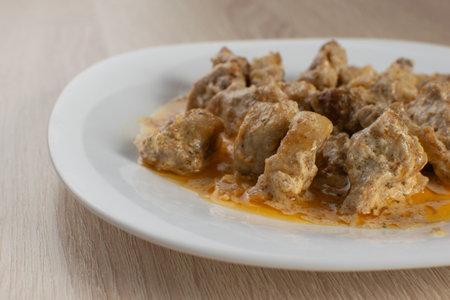 Close-Up of Succulent Chicken Curry Stew on a White Plate for Home-Cooked Cuisineの写真素材