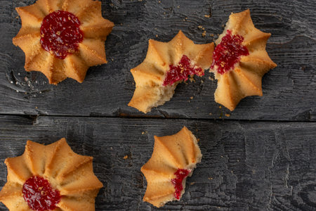 Rustic Raspberry Jam Cookies on Weathered Wood Backgroundの写真素材