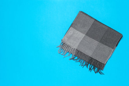 Gray Scarf on a Blue Background: Minimalist Fashion Accessory Photographyの写真素材