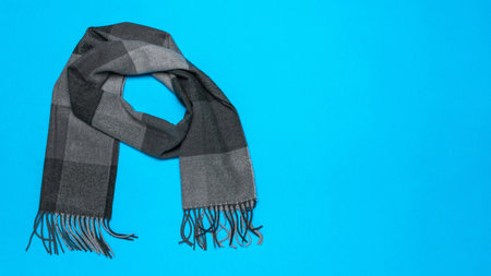 Elegant Gray Wool Scarf on Vibrant Blue Background - Winter Fashion Accessoryの写真素材