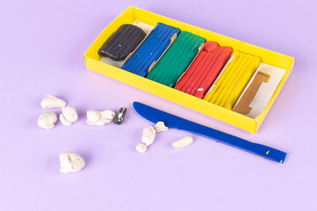 Colorful Modeling Clay Set with Knife on Purple Backgroundの写真素材