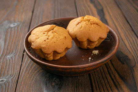 Rustic Homemade Muffins on Wooden Table in Warm Light