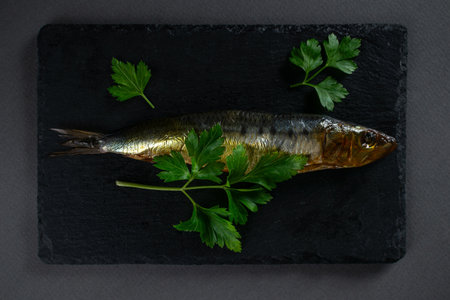 Smoked Fish with Fresh Parsley on Slate Plate - Culinary Art Conceptの写真素材