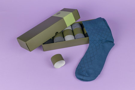 Stylish Boxed Socks on Purple Background: Elegant Packaging and Cozy Fashion Trendsの写真素材