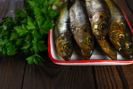 Fresh Smoked Fish with Parsley on Wooden Table: Rustic Culinary Photographyの写真素材