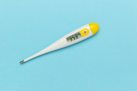 Electronic Thermometer on Blue Background: Accurate Temperature Measurement
