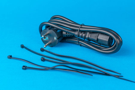 Black Power Cable with Cable Ties on Blue Background for Home and Office Use