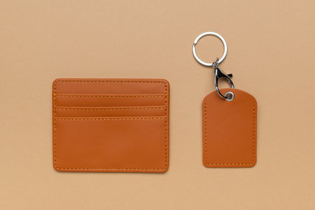 Brown Leather Card Holder and Keychain Set on Beige Background for Elegant Accessory Display