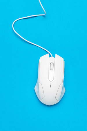 White Wired Computer Mouse on Bright Blue Background for Modern Tech Design